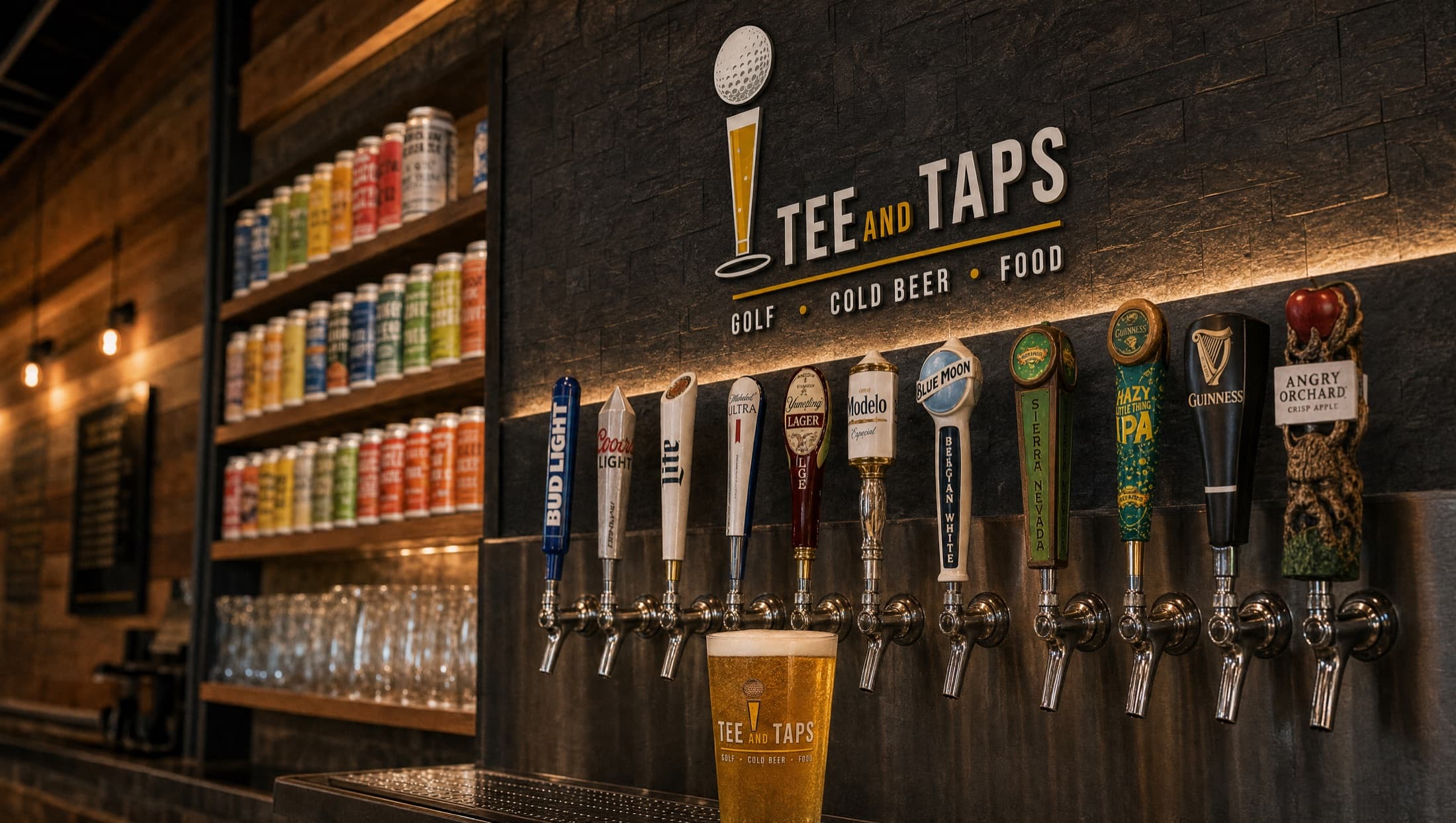 The Tee and Taps tap wall — branded handles under the logo, with shelves of canned beer behind the bar